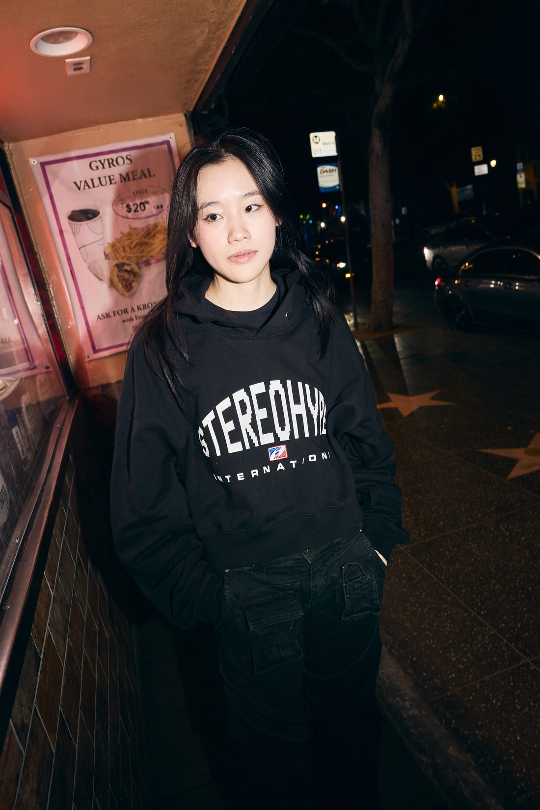 Solo portrait at night, black STEREOHYPE INTERNATIONAL hoodie